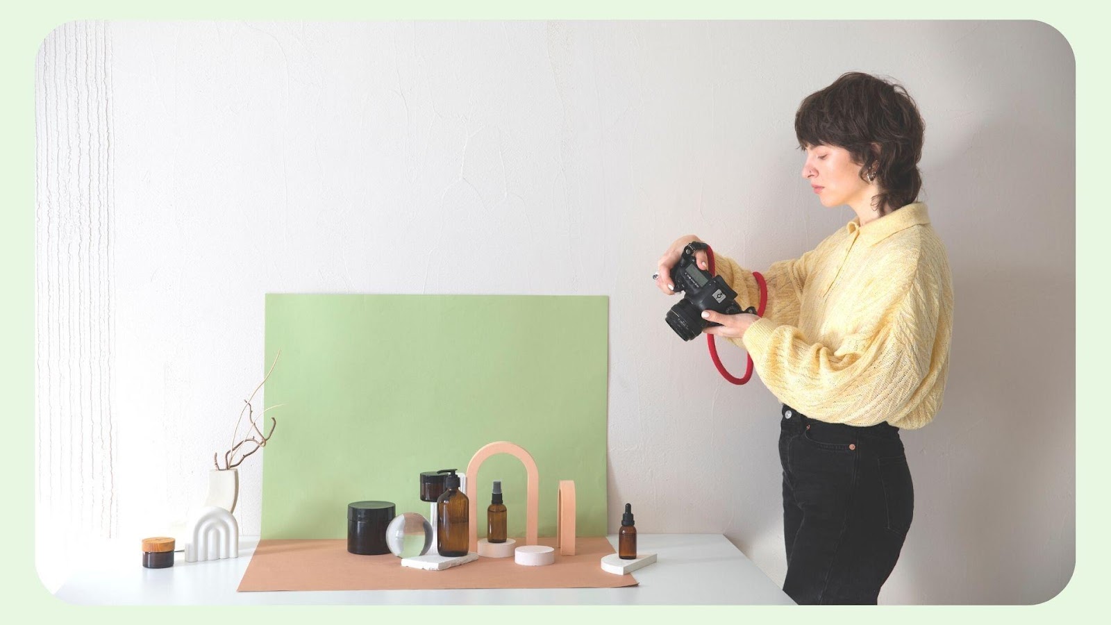 A photographer taking photos of a series of beauty products.