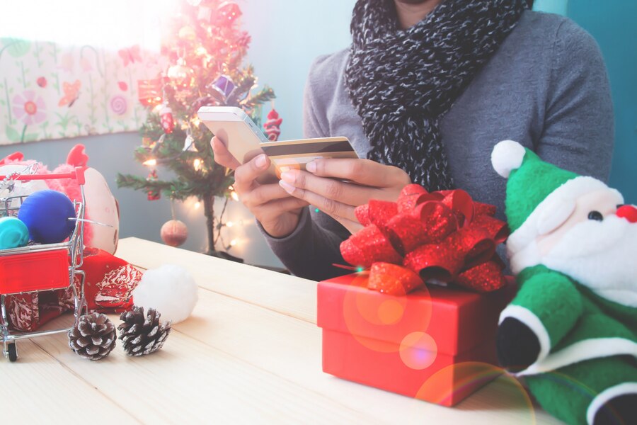 christmas concept with woman using mobile phone credit card 1428 2355